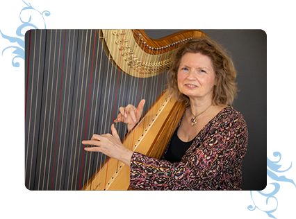 Dominique standing with her harp